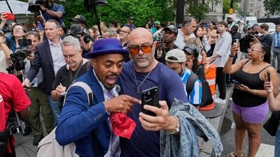 Supporters of Diddy react outside Manhattan federal court after Combs was acquitted on the most serious charges at his New York trial. (AP)