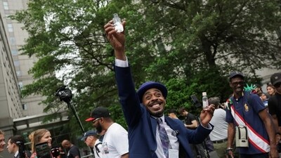After the Diddy trial ruling, a man outside the court waved baby oil in the air. (AP)