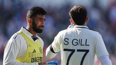 India's Jasprit Bumrah, left, carries refreshments for captain Shubman Gill during a break on day one of the second cricket test match between England and India at Edgbaston (AP)