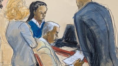 Sean ' Diddy' Combs, center, reads a jury note with his defense attorneys during jury deliberations for his sexual misconduct trial in Manhattan federal court, Monday, June 30, 2025, in New York. (Elizabeth Williams via AP) (AP)