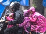 People going through the rain at Cotton Green in Mumbai, India, on Wednesday.