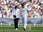 England's Chris Woakes speaks with umpire Sharfuddoula Saikat after an unsuccessful appeal for the LBW wicket of India's Karun Nair