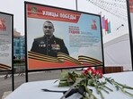 A view shows flowers placed in front of a board with a photograph of Major General Mikhail Gudkov, in the far eastern city of Vladivostok, Russia.