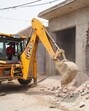 The police in coordination with the district administration demolished three illegal constructions owned by drug smugglers on panchayati land at Dogranwal village on Wednesday. (HT Photo) The police in coordination with the district administration demolished three illegal constructions owned by drug smugglers on panchayati land at Dogranwal village on Wednesday. (HT Photo)