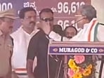 CM Siddaramaiah was seen raising his hand on a senior cop during the public meeting in Belagavi. 