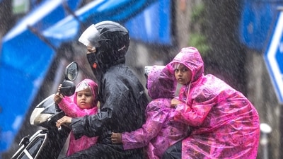 People going through the rain at Cotton Green in Mumbai, India, on Wednesday. (Photo by Satish Bate/ Hindustan Times)