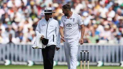 England's Chris Woakes speaks with umpire Sharfuddoula Saikat after an unsuccessful appeal for the LBW wicket of India's Karun Nair (Action Images via Reuters)
