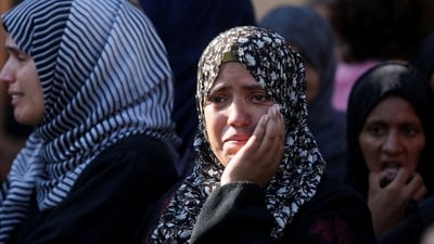 Mourners react during the funeral of Palestinians, who, according to Gaza's health ministry, were killed in an overnight Israeli strike on a tent, at Nasser Hospital in Khan Younis, southern Gaza Strip. (REUTERS)
