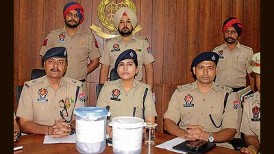 Khanna police officials with the seized drugs. (HT Photo) Khanna police officials with the seized drugs. (HT Photo)
