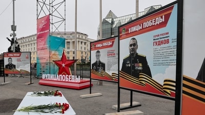 A view shows flowers placed on a table in front of a board with a photograph of Major General Mikhail Gudkov, the deputy head of the Russian Navy, in the far eastern city of Vladivostok, Russia, July 3, 2025. (Reuters)