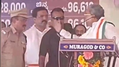 CM Siddaramaiah was seen raising his hand on a senior cop during the public meeting in Belagavi. CM Siddaramaiah was seen raising his hand on a senior cop during the public meeting in Belagavi.