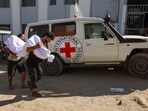 Palestinian men carry the body of a person reportedly killed while waiting for aid delivery in Gaza City, on July 3, 2025.