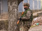 A security personnel stands guard near the site of the encounter, at Gujjarpati area in Sopore, Baramulla district of Jammu and Kashmir,