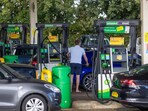 A customer uses a fuel pump at a petrol station.