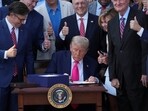 US President Donald Trump signs the sweeping spending and tax legislation, known as the "One Big Beautiful Bill Act," at the White House in Washington.