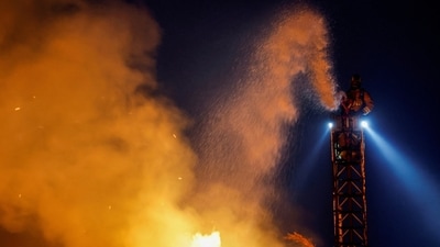 A firefighter works to extinguish flames, as powerful winds fueled the devastating wildfires in the Los Angeles, California.&nbsp; (Reuters)