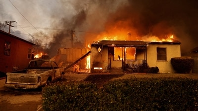 A house burns in Altadena, California as winds fueled the devastating wildfires in the Los Angeles area forcing people to leave their homes.&nbsp; (Reuters)