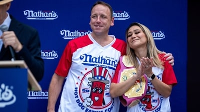 Joey Chestnut, 16-time champion, and Miki Sudo, 10-time champion, stand next to each other during the official weigh-in ceremony (REUTERS)