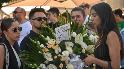 People hold a floral wreath bearing the message “Thank You Diogo” as they queue outside the funeral chapel for the wake of Liverpool forward Diogo Jota. (Photo by MIGUEL RIOPA / AFP) (AFP) People hold a floral wreath bearing the message “Thank You Diogo” as they queue outside the funeral chapel for the wake of Liverpool forward Diogo Jota. (Photo by MIGUEL RIOPA / AFP) (AFP)