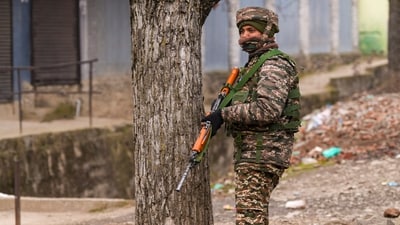 A security personnel stands guard near the site of the encounter, at Gujjarpati area in Sopore, Baramulla district of Jammu and Kashmir, (PTI) A security personnel stands guard near the site of the encounter, at Gujjarpati area in Sopore, Baramulla district of Jammu and Kashmir, (PTI)