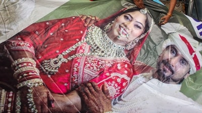 Raja Raghuvanshi's family members, cut out the picture of his wife Sonam Raghuvanshi from a poster of their marriage after she was accused of plotting Raja's murder in Meghalaya, in Indore, (PTI) Raja Raghuvanshi's family members, cut out the picture of his wife Sonam Raghuvanshi from a poster of their marriage after she was accused of plotting Raja's murder in Meghalaya, in Indore, (PTI)