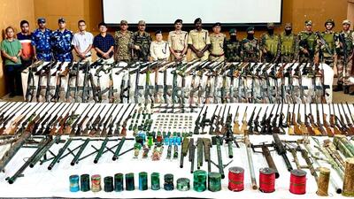 Security forces in Manipur pose with the arms cache after its recovery. Security forces in Manipur pose with the arms cache after its recovery.