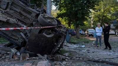 Women stand next to the wreckage of a car following mass Russian drone and missile strikes on Ukraine's capital Kyiv on July 4, 2025, amid the Russian invasion of Ukraine. (AFP) Women stand next to the wreckage of a car following mass Russian drone and missile strikes on Ukraine's capital Kyiv on July 4, 2025, amid the Russian invasion of Ukraine. (AFP)