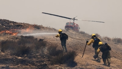 Firefighters use helicopters and water hose in efforts to tackle the Madre Fire near New Cuyama, California.&nbsp; (Reuters)
