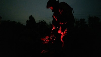 A Ukrainian soldier preparing a heavy combat drone before its flight over Russian troop positions at night. A Ukrainian soldier preparing a heavy combat drone before its flight over Russian troop positions at night.