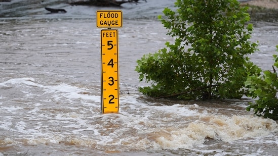 A flood gauge marks the height of water flowing over a farm-to-market road near Kerrville, Texas, on Friday (AP)