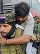 A securityman carries an injured after the mishap in Chanderkote area of Ramban on Saturday. (HT photo) A securityman carries an injured after the mishap in Chanderkote area of Ramban on Saturday. (HT photo)