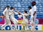 Pat Cummins celebrates with his teammates after taking a remarkable catch to dismiss Keacy Carty. Pat Cummins celebrates with his teammates after taking a remarkable catch to dismiss Keacy Carty.