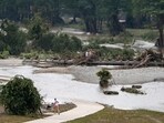 A jogger takes a detour around a flooded running path in Louise Hays Park, along the banks of the Guadalupe River, Saturday, July 5, 2025, in Kerrville, Texas. A jogger takes a detour around a flooded running path in Louise Hays Park, along the banks of the Guadalupe River, Saturday, July 5, 2025, in Kerrville, Texas.