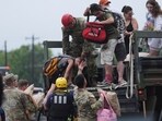 First responders deliver people to a reunification center after flash flooding it the area, First responders deliver people to a reunification center after flash flooding it the area,