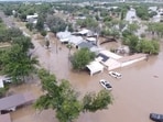 A drone view shows houses flooded following torrential rains that unleashed flash floods along the Guadalupe River in San Angelo