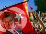 A supporter holds a flag of Istanbul's detained Mayor Ekrem Imamoglu and the First President of the Republic of Turkey Mustafa Kemal Ataturk during a protest A supporter holds a flag of Istanbul's detained Mayor Ekrem Imamoglu and the First President of the Republic of Turkey Mustafa Kemal Ataturk during a protest