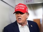 US President Donald Trump speaks to members of the media on board Air Force One on the way to New Jersey.