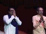 Uddhav Thackeray and his cousin Raj Thackeray greet the crowd at their reunion rally in Mumbai on Saturday.