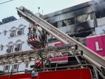 Fire personnel at a Vishal Mega Mart showroom, where a fire broke out on Friday, at Karol Bagh area, in New Delhi, Saturday, July 5, 2025.