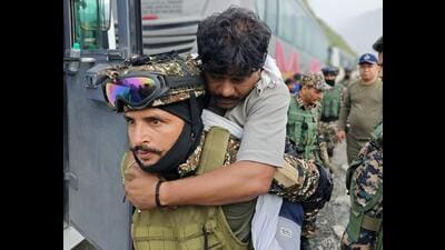 A securityman carries an injured after the mishap in Chanderkote area of Ramban on Saturday. (HT photo) A securityman carries an injured after the mishap in Chanderkote area of Ramban on Saturday. (HT photo)