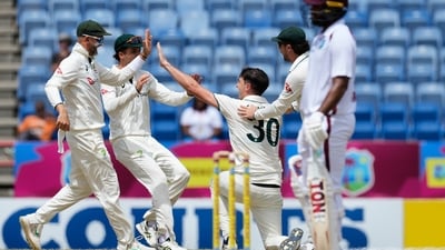 Pat Cummins celebrates with his teammates after taking a remarkable catch to dismiss Keacy Carty. (AP) Pat Cummins celebrates with his teammates after taking a remarkable catch to dismiss Keacy Carty. (AP)