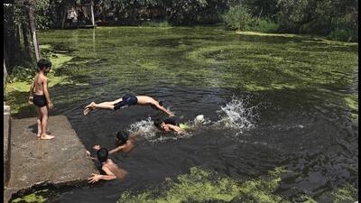 Children take bath in Dal Lake in Srinagar on Saturday. (Waseem Andrabi /HT) Children take bath in Dal Lake in Srinagar on Saturday. (Waseem Andrabi /HT)