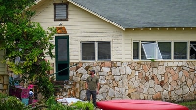 A person surveys the area near the sleeping quarters at Camp Mystic along the banks of the Guadalupe River after a flash flood swept through the area Saturday, July 5, 2025, in Hunt, Texas. (AP Photo/Julio Cortez) (AP) A person surveys the area near the sleeping quarters at Camp Mystic along the banks of the Guadalupe River after a flash flood swept through the area Saturday, July 5, 2025, in Hunt, Texas. (AP Photo/Julio Cortez) (AP)