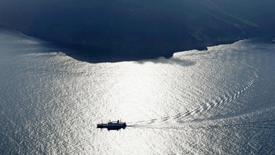 An aerial view shows a ferry carrying residents and visitors evacuating from Akuseki Island, as multiple earthquakes hit the island in Japan. (via REUTERS)