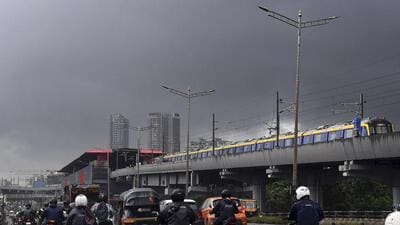 Mumbai: Dark clouds cover the sky as people commute amid rains, in Mumbai, Wednesday, July 2, 2025. (PTI Photo)(PTI07_02_2025_000140B) (PTI)