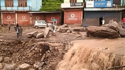 People stand near silt and debris after cloudburst-triggered flash floods at Karsog, in Mandi district, (PTI) People stand near silt and debris after cloudburst-triggered flash floods at Karsog, in Mandi district, (PTI)