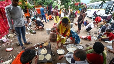 Pilgrims prepare food under a tree as they wait to get themselves registered for the annual Amarnath Yatra, in Jammu. (PTI) Pilgrims prepare food under a tree as they wait to get themselves registered for the annual Amarnath Yatra, in Jammu. (PTI)