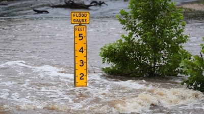 A flood gauge marks the height of water flowing over a farm-to-market road near Kerrville, Texas, on Friday, July 4, 2025. (AP Photo/Eric Gay) (AP)