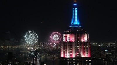 The Empire State Building glowed red, white, and blue as fireworks exploded over the Manhattan skyline during Fourth of July celebrations.(Photo by TIMOTHY A. CLARY / AFP) (AFP) The Empire State Building glowed red, white, and blue as fireworks exploded over the Manhattan skyline during Fourth of July celebrations.(Photo by TIMOTHY A. CLARY / AFP) (AFP)