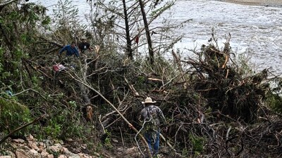 Volunteers search for missing people near Camp Mystic, the site of where at least 20 girls went missing after flash flooding in Hunt, Texas, on July 5, 2025. (AFP) Volunteers search for missing people near Camp Mystic, the site of where at least 20 girls went missing after flash flooding in Hunt, Texas, on July 5, 2025. (AFP)